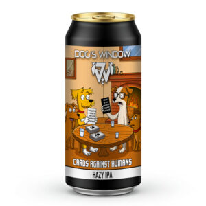 A 440ml black craft beer can with a gold top featuring the "Dog's Window" logo. The label displays a cartoon illustration of four dogs sitting around a wooden table in a cosy room with a fireplace, playing a card game. One dog holds a black card reading "What is an owner's biggest betrayal", while another holds a white card reading "Snapping a treat in half and pretend it's two". The text at the bottom reads "Cards Against Humans" and "Hazy IPA".