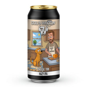 A black beer can with a gold top for Dog's Window Brewery's 'Cheese Tax' Hazy IPA. The label art depicts a bearded man wearing a 'Chef in Training' apron slicing cheese on a kitchen counter. A golden dog sits on the tiled floor, looking up eagerly for a piece.